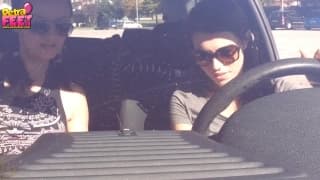 Les pieds d'une brunette dans la voiture