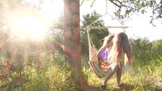 Masturbation de blonde nue dans un hamac en plein air